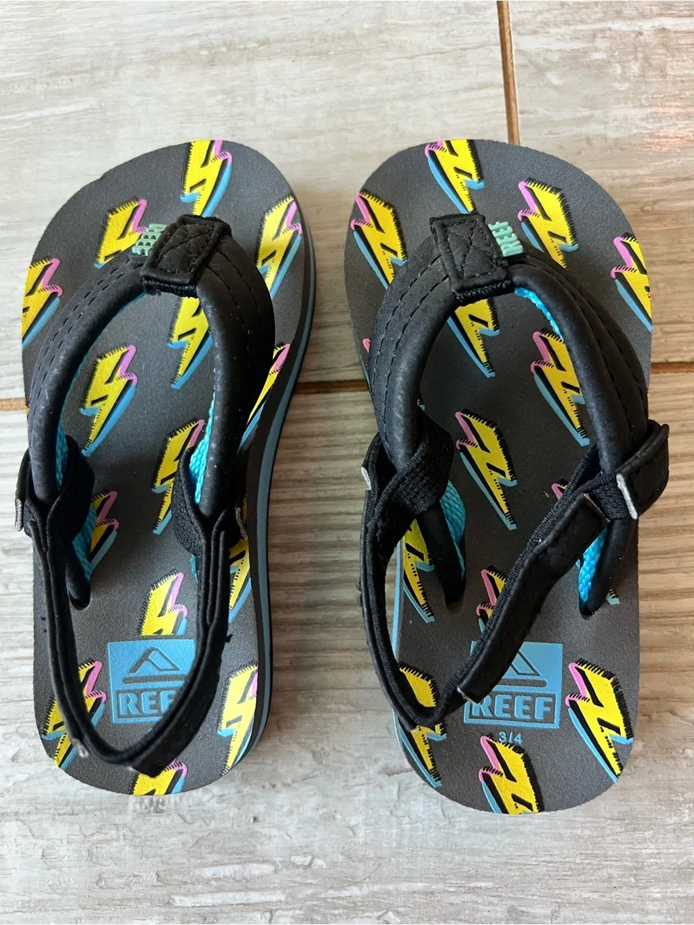 Reef Kids Black Flip Flop with Yellow & Pink Lightning Accents